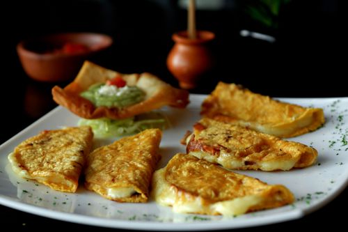 Free Tasty Mexican quesadillas served with a side of guacamole, making a perfect appetizer or snack. Stock Photo