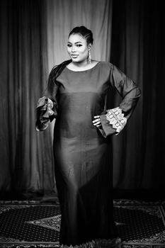 Black and white portrait of a woman in traditional attire with an elegant pose.