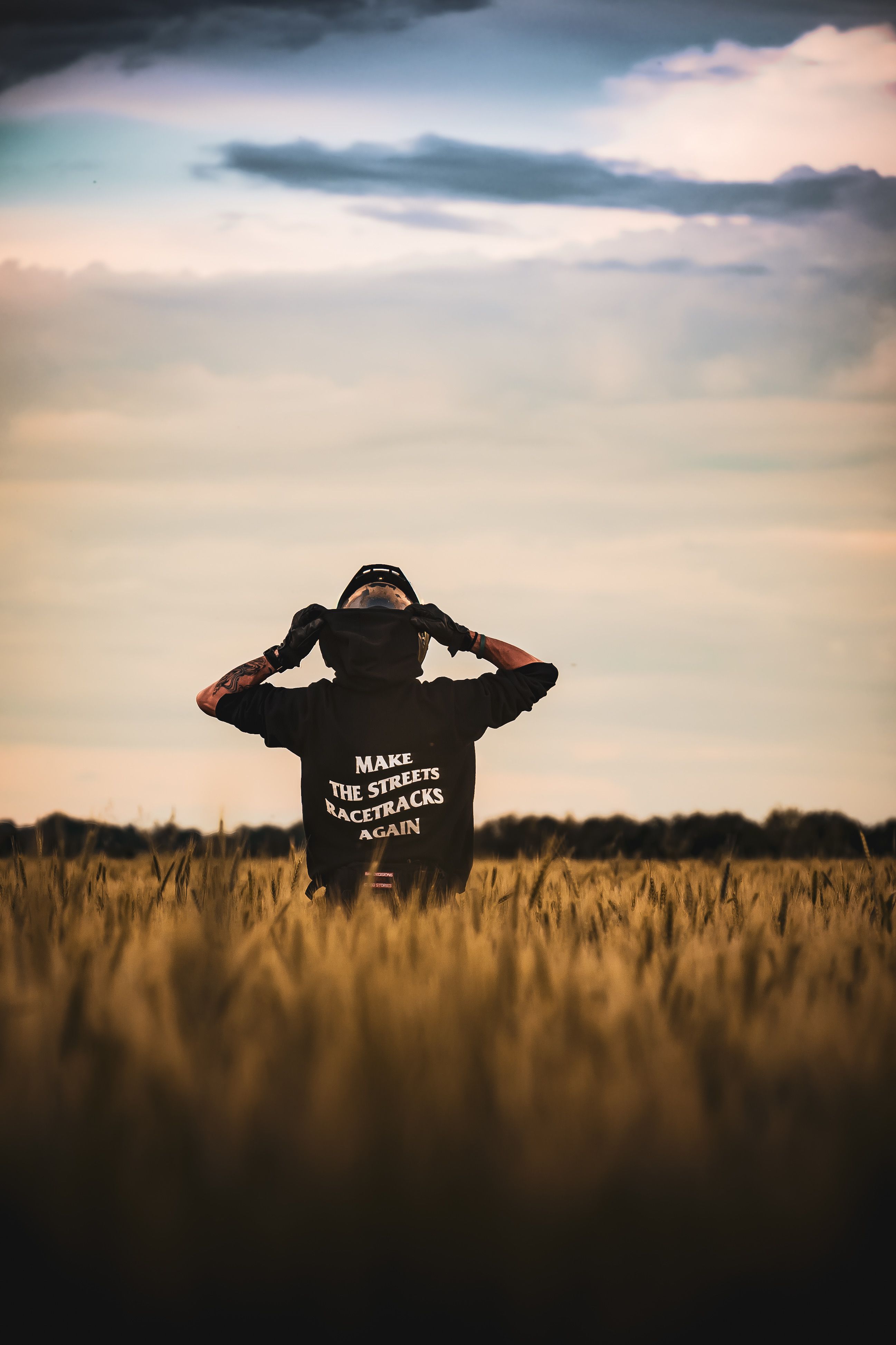 Person in Field with Motivational Hoodie Back View · Free Stock Photo
