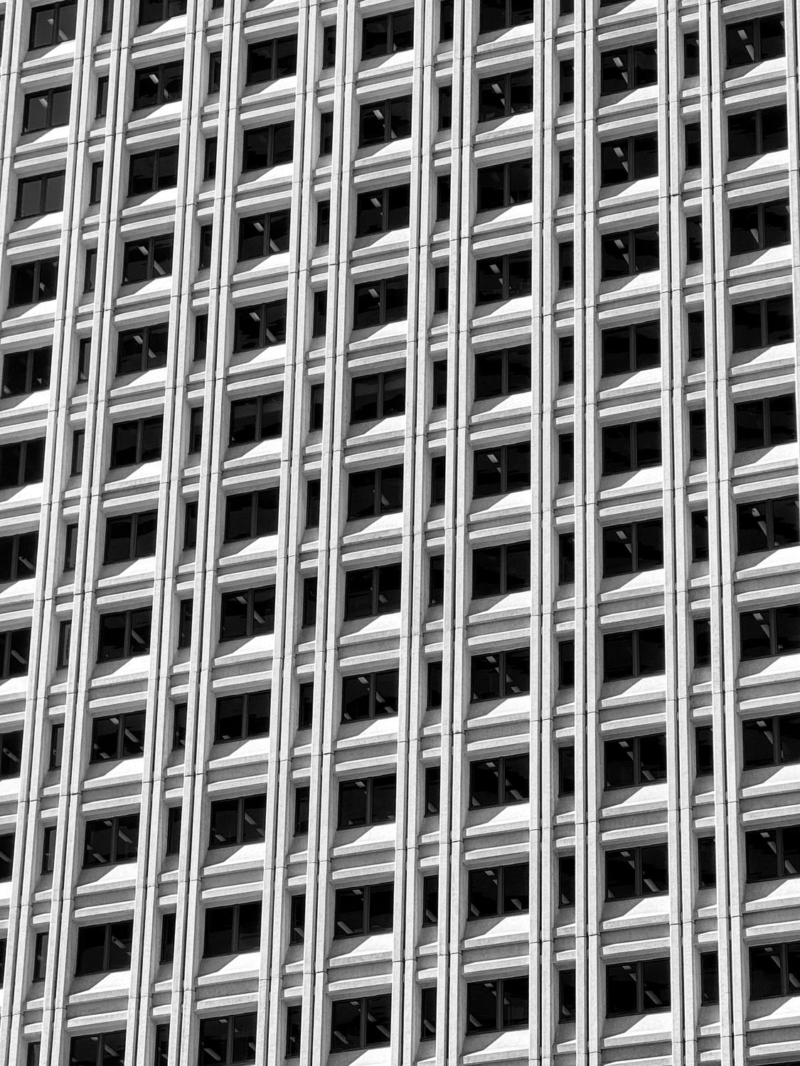 Modern Skyscraper Facade with Geometric Patterns · Free Stock Photo