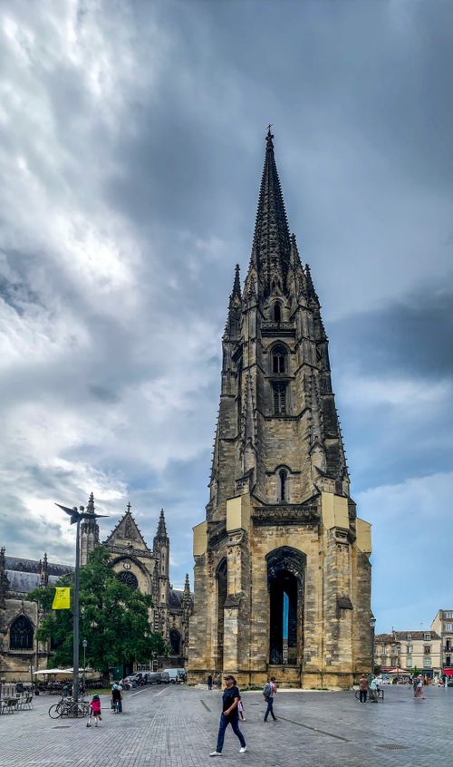Free Gothic Saint-Michel Basilica bell tower in Bordeaux against a dramatic sky. Stock Photo