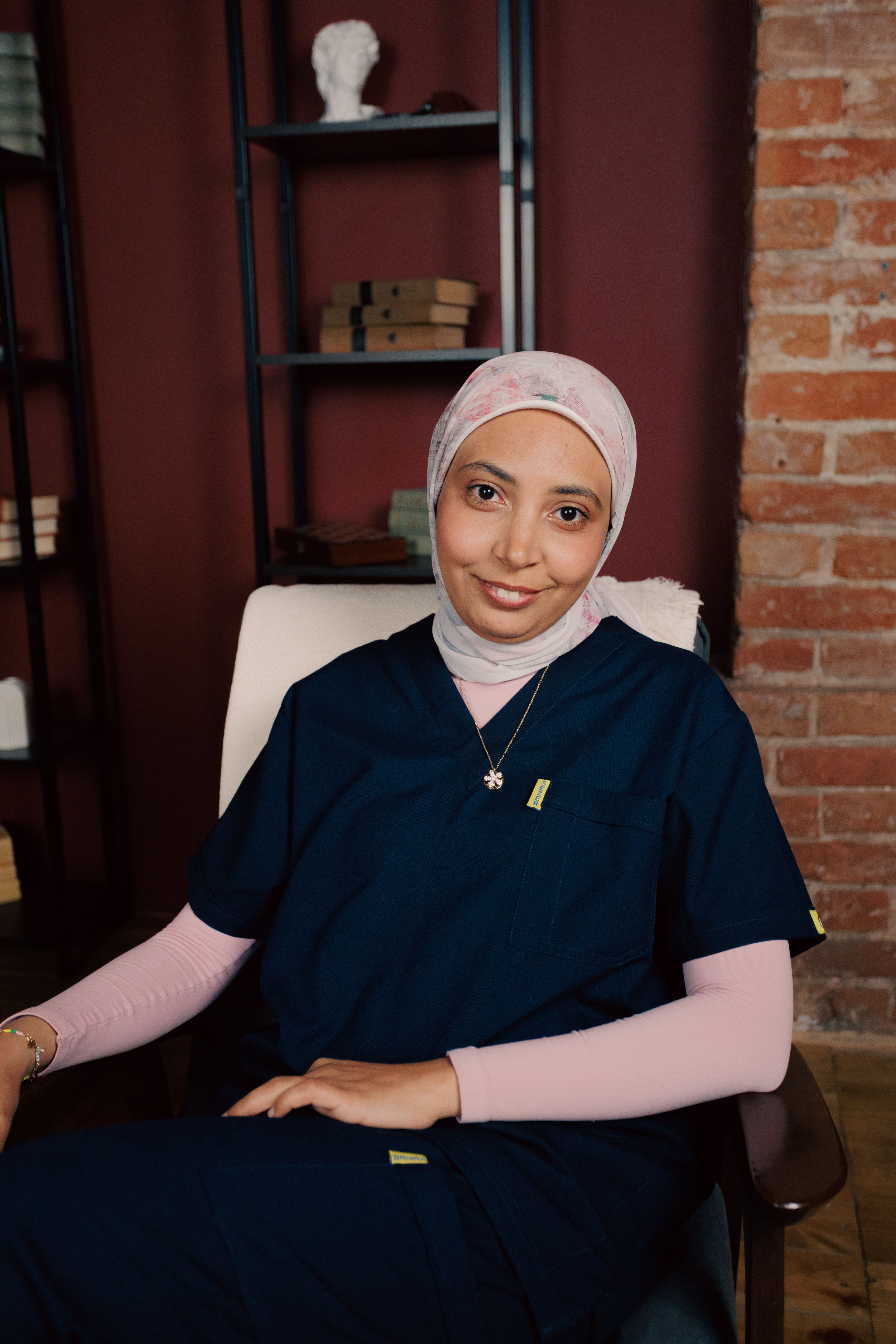 Female healthcare worker in relaxing office space, showcasing professionalism and calm.