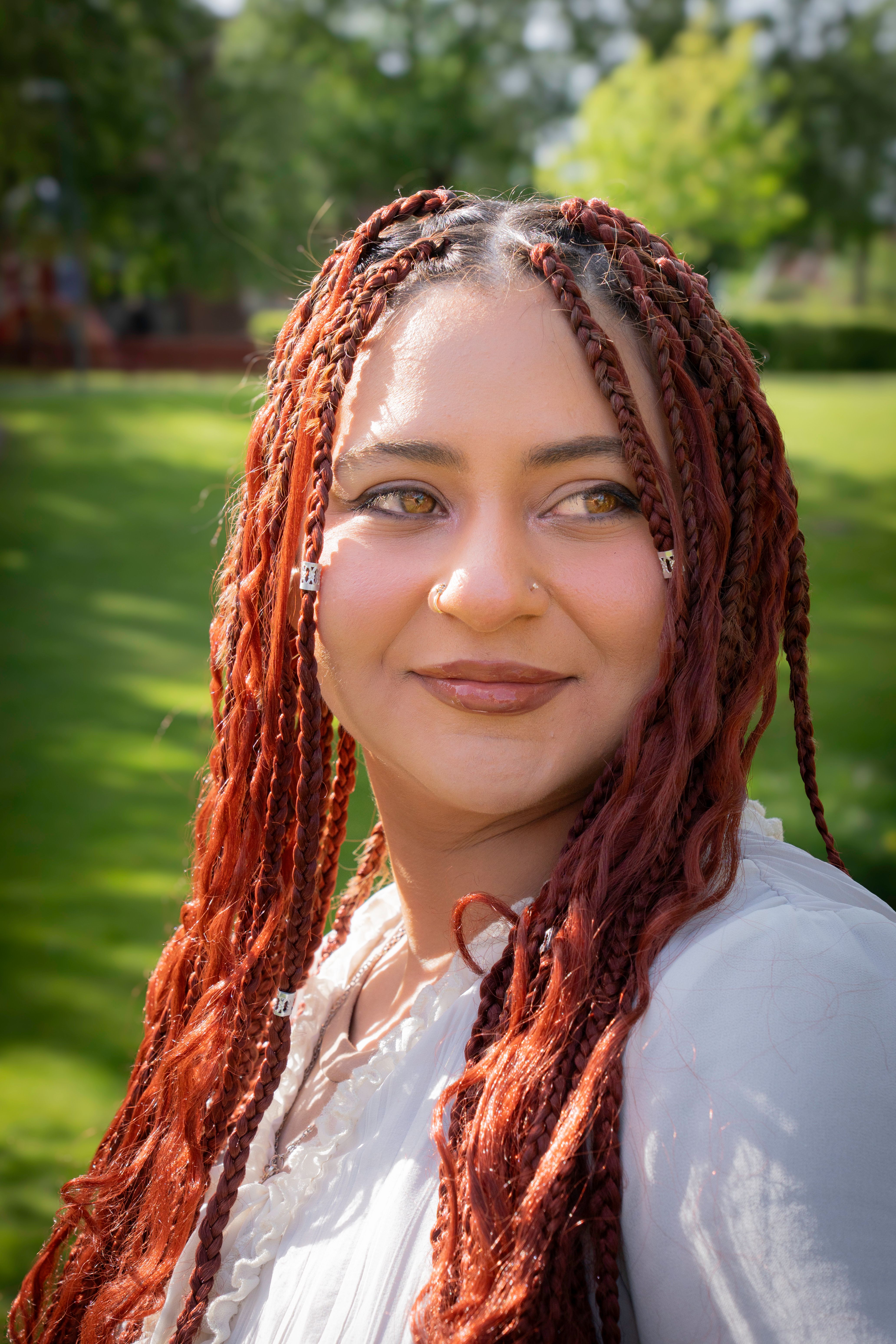 Portrait of Smiling Woman with Braided Hair Outdoors · Free Stock Photo