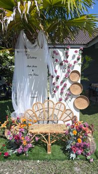 Beautiful outdoor wedding decoration with rattan furniture and floral accents in Terengganu, Malaysia. - Fotografer Sidoarjo