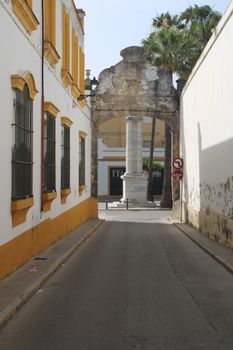 Charming old town street in El Puerto de Santa María, Andalucía showcasing a historic archway.