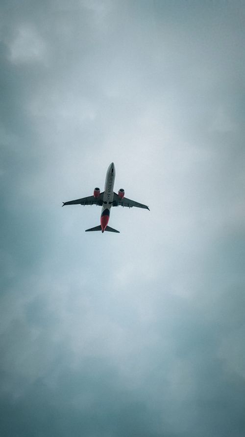 Free Aerial view of a commercial airplane soaring through a cloudy sky above Pune, India. Stock Photo