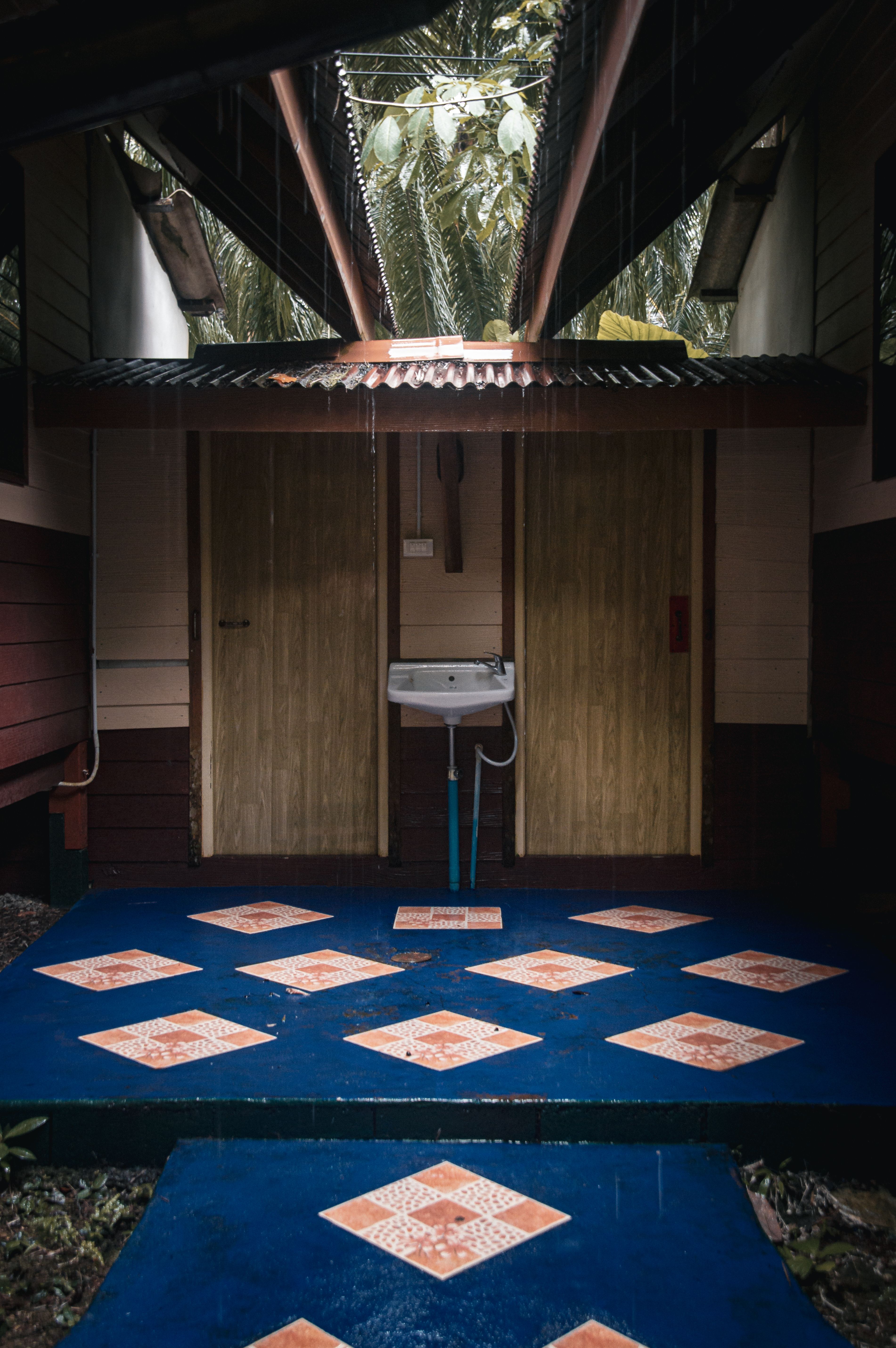 Discover a rustic outdoor washroom with unique tile flooring in Krabi, Thailand, perfect for nature retreats.