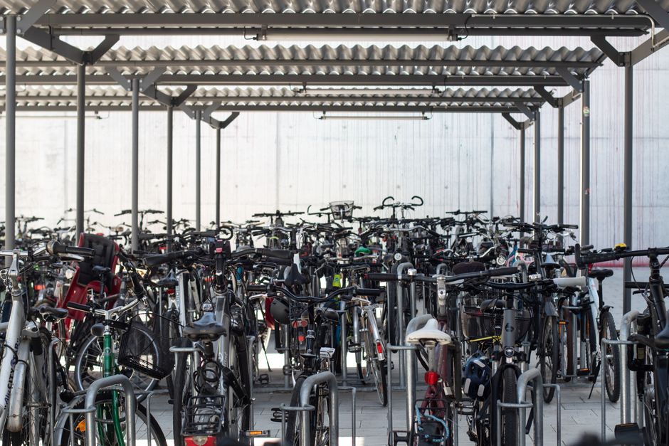Rows of bicycles parked under a shelter at Augsburg train station, showcasing urban mobility.