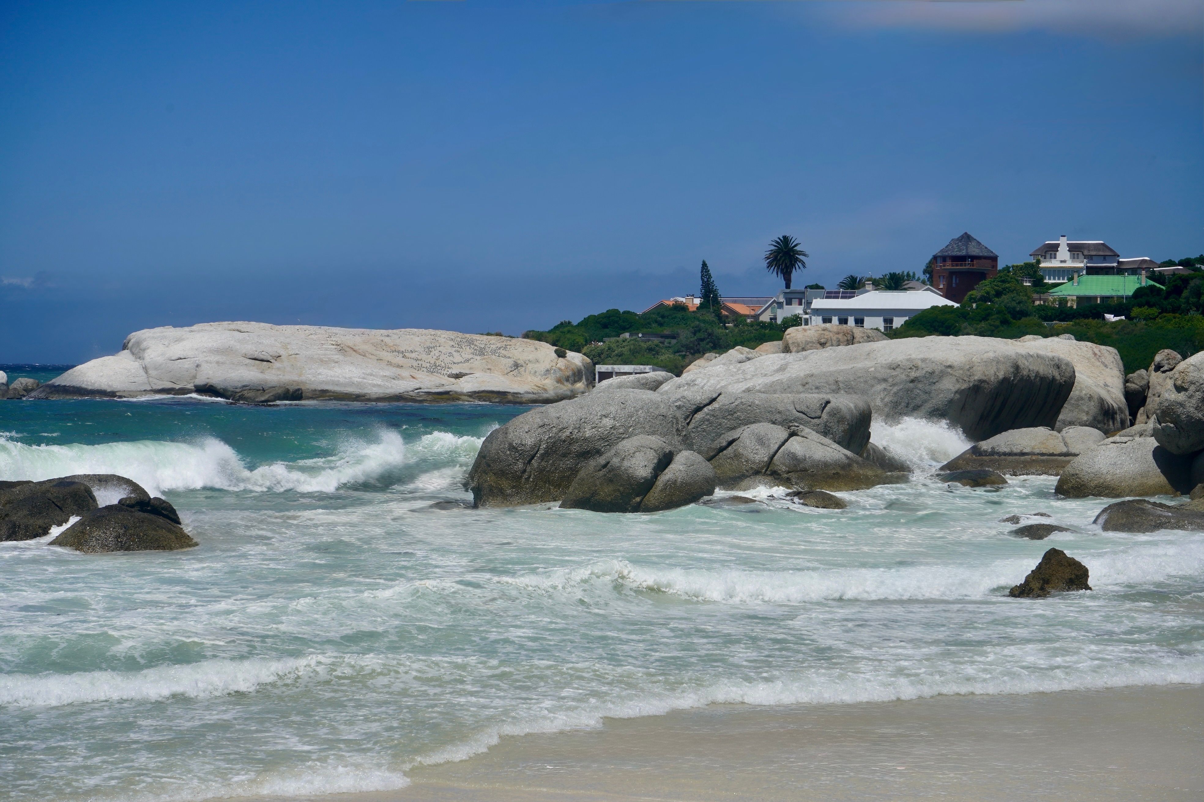 Clifton Fourth Beach seen from the stairway above, white sand between granite boulders
