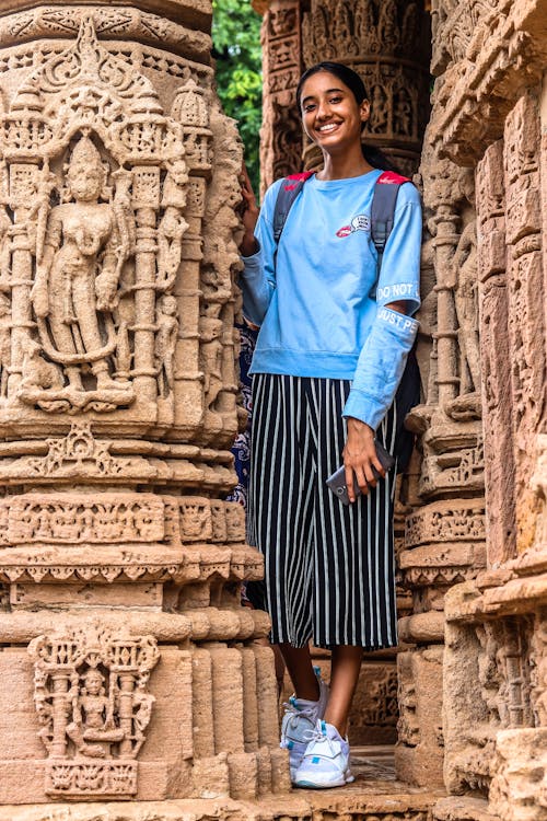 Woman Standing Beside Brown Statue