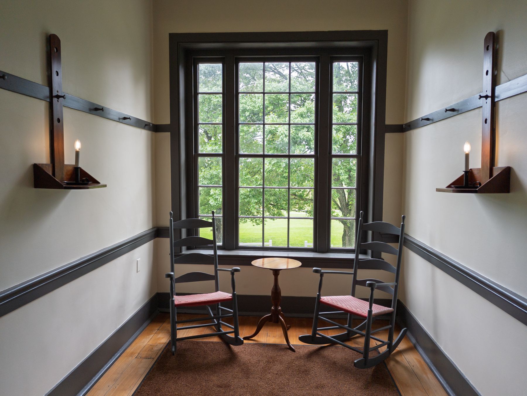 Historic Shaker room in Harrodsburg, Kentucky, with traditional wood flooring and simple period furnishings.