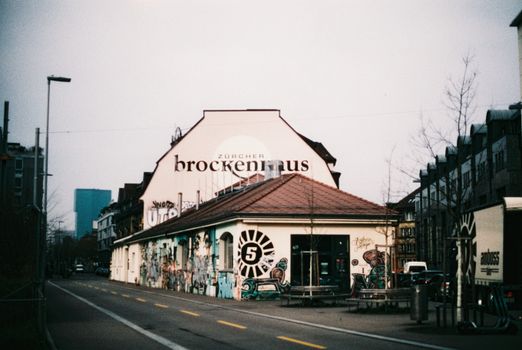 Artistic street view of Zürcher Brockenhaus with urban graffiti in Zurich.