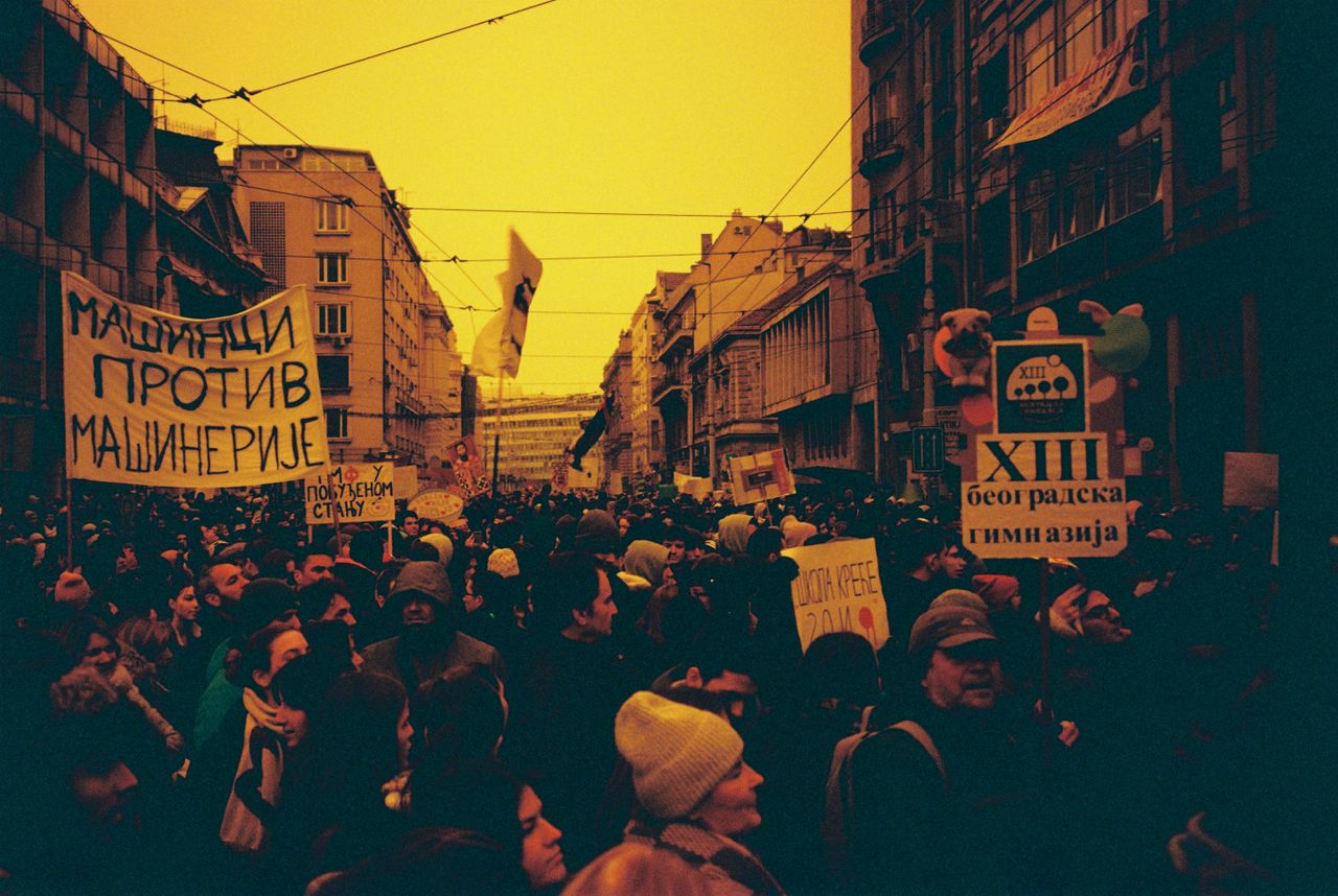 large crowd demonstrating with banners in urban city street vibrant at