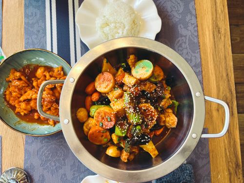 Free A vibrant spread of Asian cuisine featuring stir-fried vegetables, rice, and chicken in Astana, Kazakhstan. Stock Photo