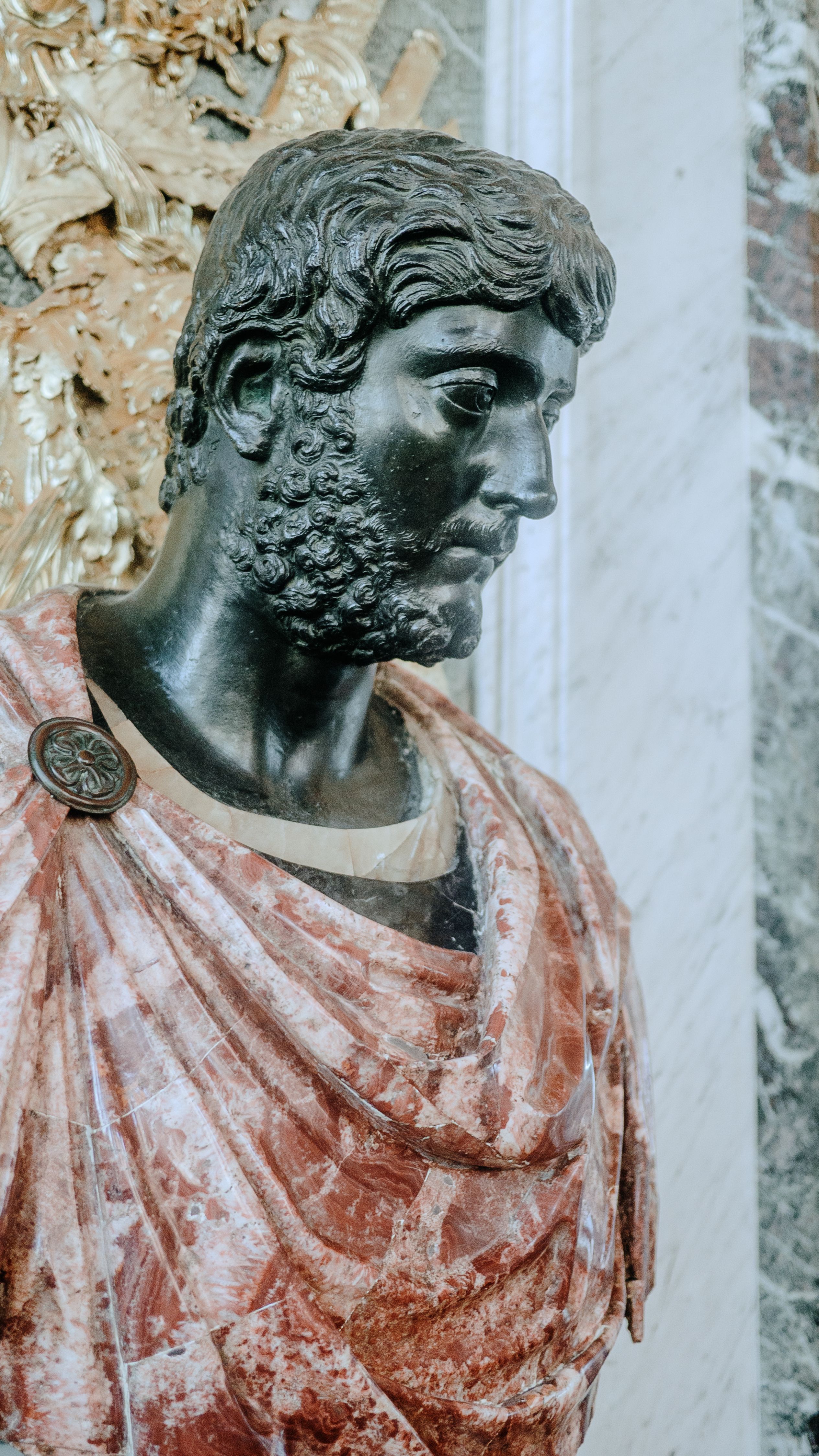 Intricate Roman bust sculpture inside the historic Versailles Palace.
