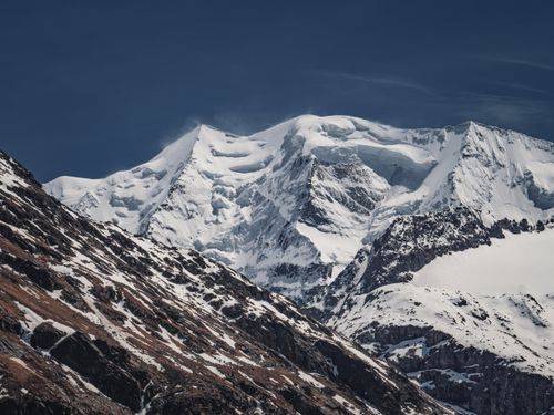 Free Breathtaking view of snow-covered Alps in Pontresina, Switzerland under a clear blue sky. Stock Photo