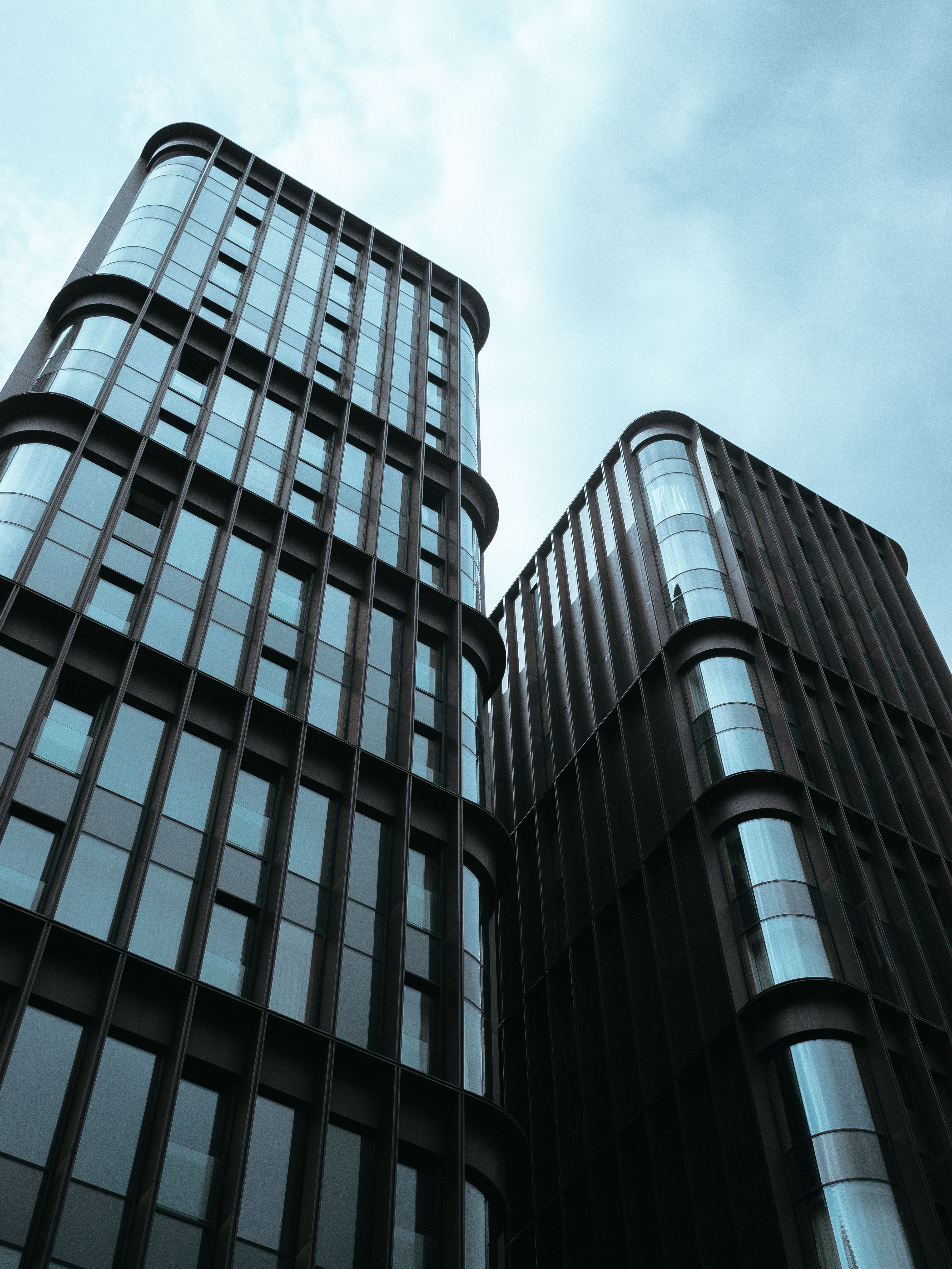 Modern High-Rise Office Buildings Against Blue Sky · Free Stock Photo