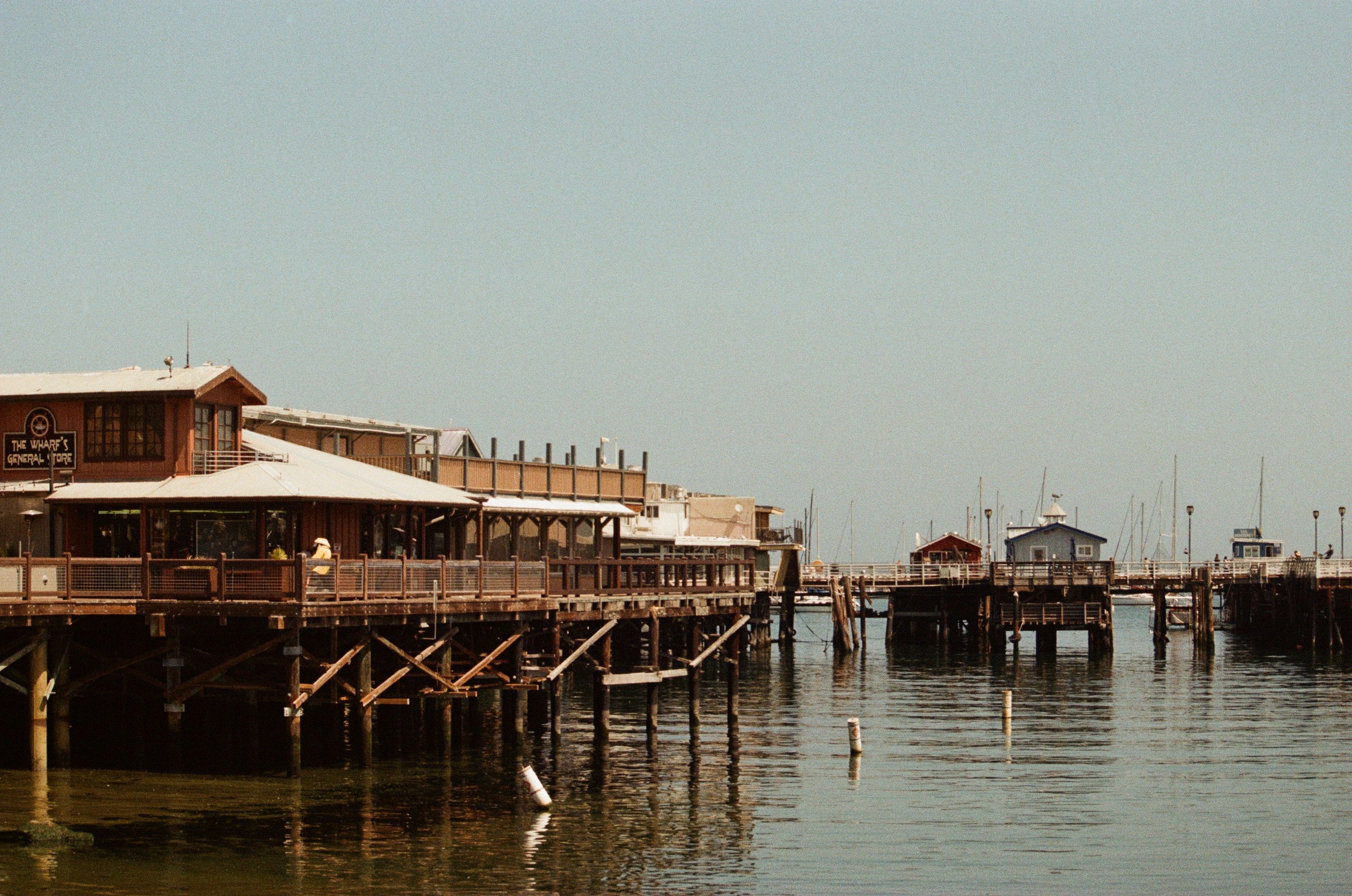 Scenic view of Monterey's wharf showcasing fishing piers and calm waters.