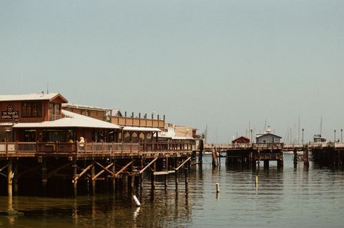 Free Scenic view of Monterey's wharf showcasing fishing piers and calm waters. Stock Photo
