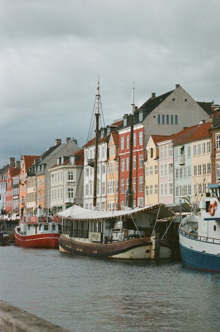 Colorful buildings and boats along Nyhavn Canal, Copenhagen, reflecting Scandinavian charm.