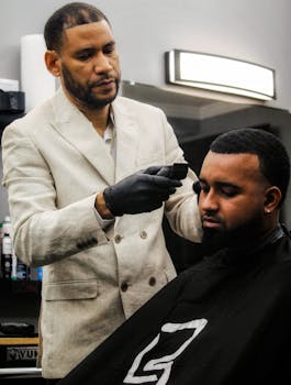 Experienced barber providing a precise haircut to a customer in a stylish barbershop.