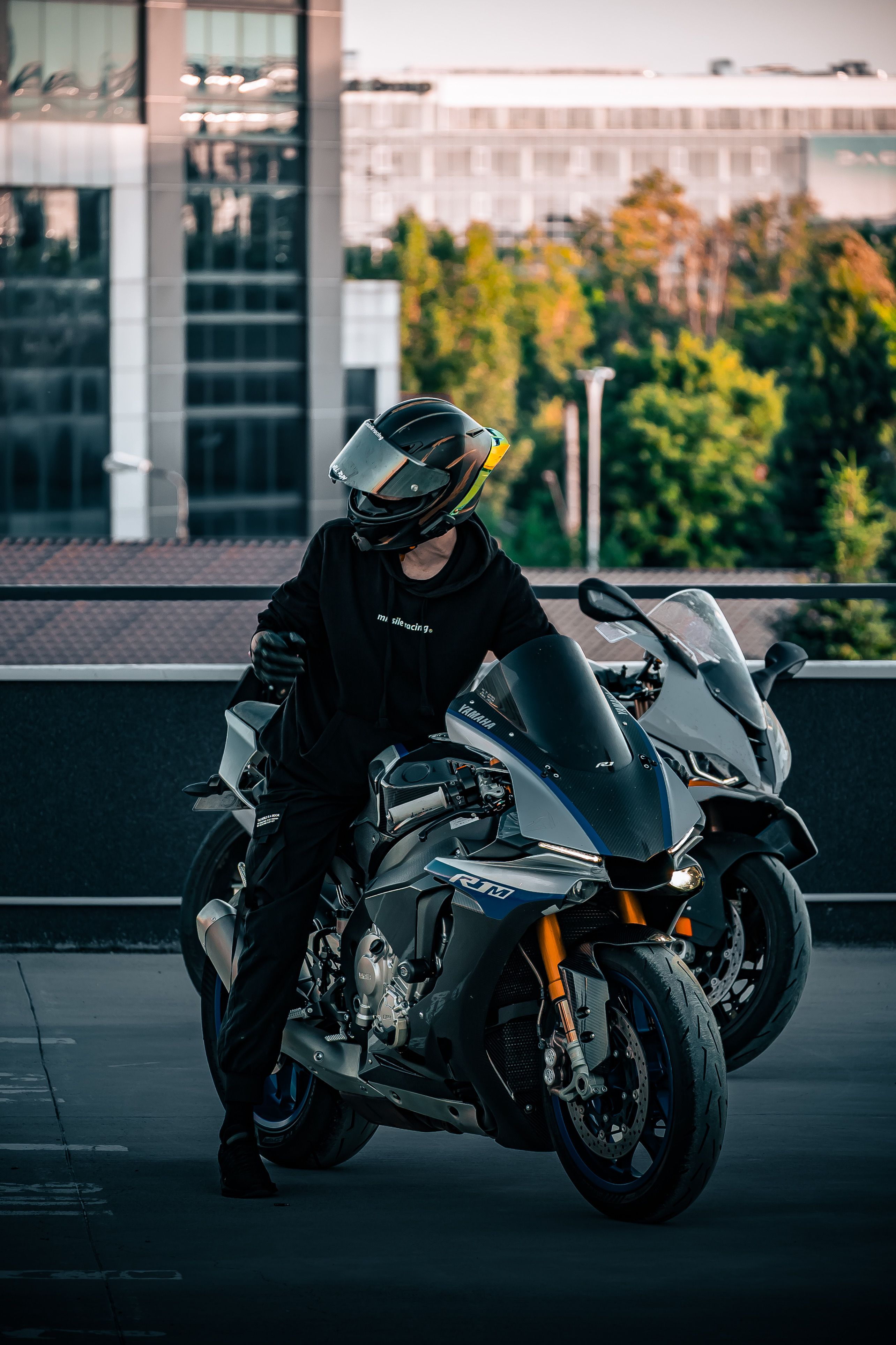 Modern Motorcycle Rider on Urban Rooftop · Free Stock Photo