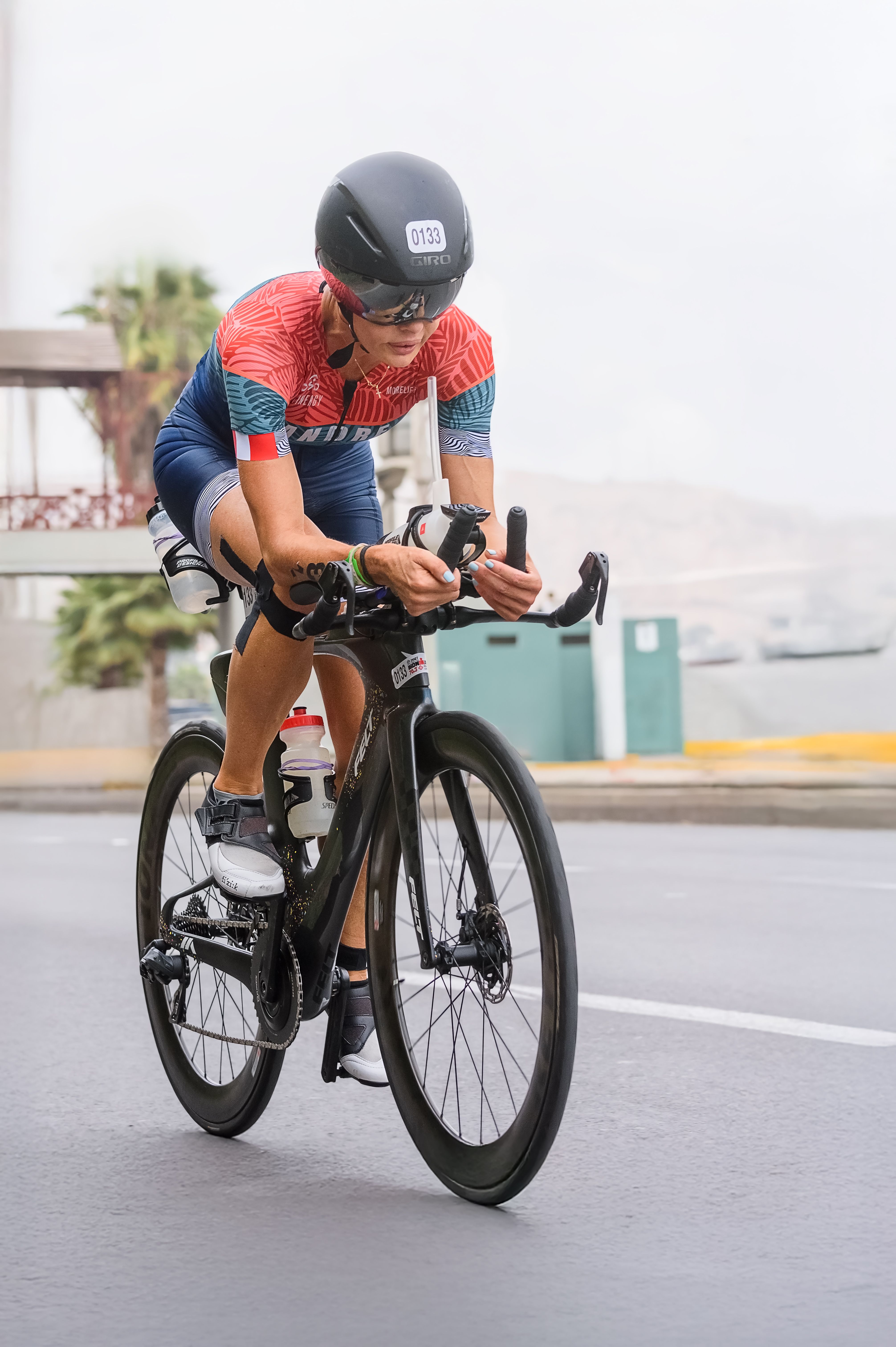 A determined cyclist competes in a triathlon event on the streets of Peru.