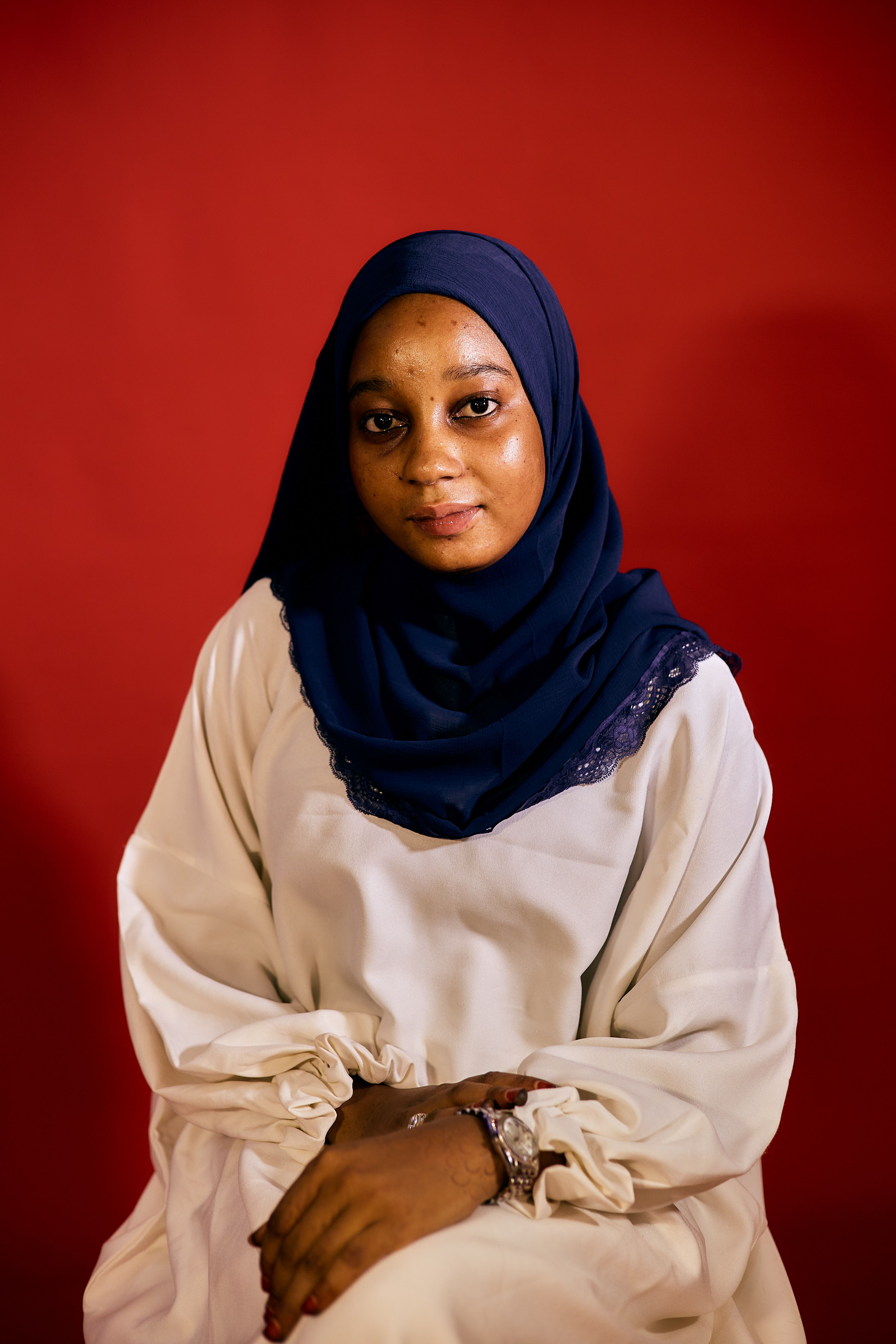 Elegant Portrait of Woman in Hijab on Red Background · Free Stock Photo