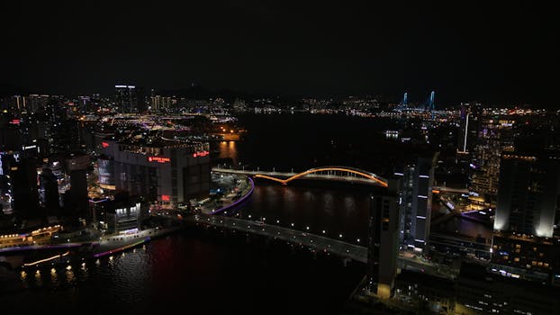 A breathtaking view of Busan at night showcasing the illuminated Gwangandaegyo Bridge and city skyline.