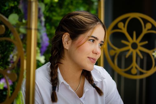 Free Young woman with braided hair in a reflective pose outdoors. Stock Photo