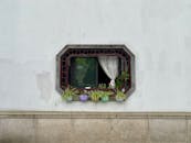 Charming Window with Flower Pots on White Wall