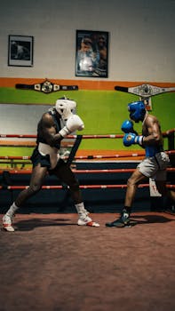 Two boxers sparring in a gym, showcasing technique and sportsmanship.