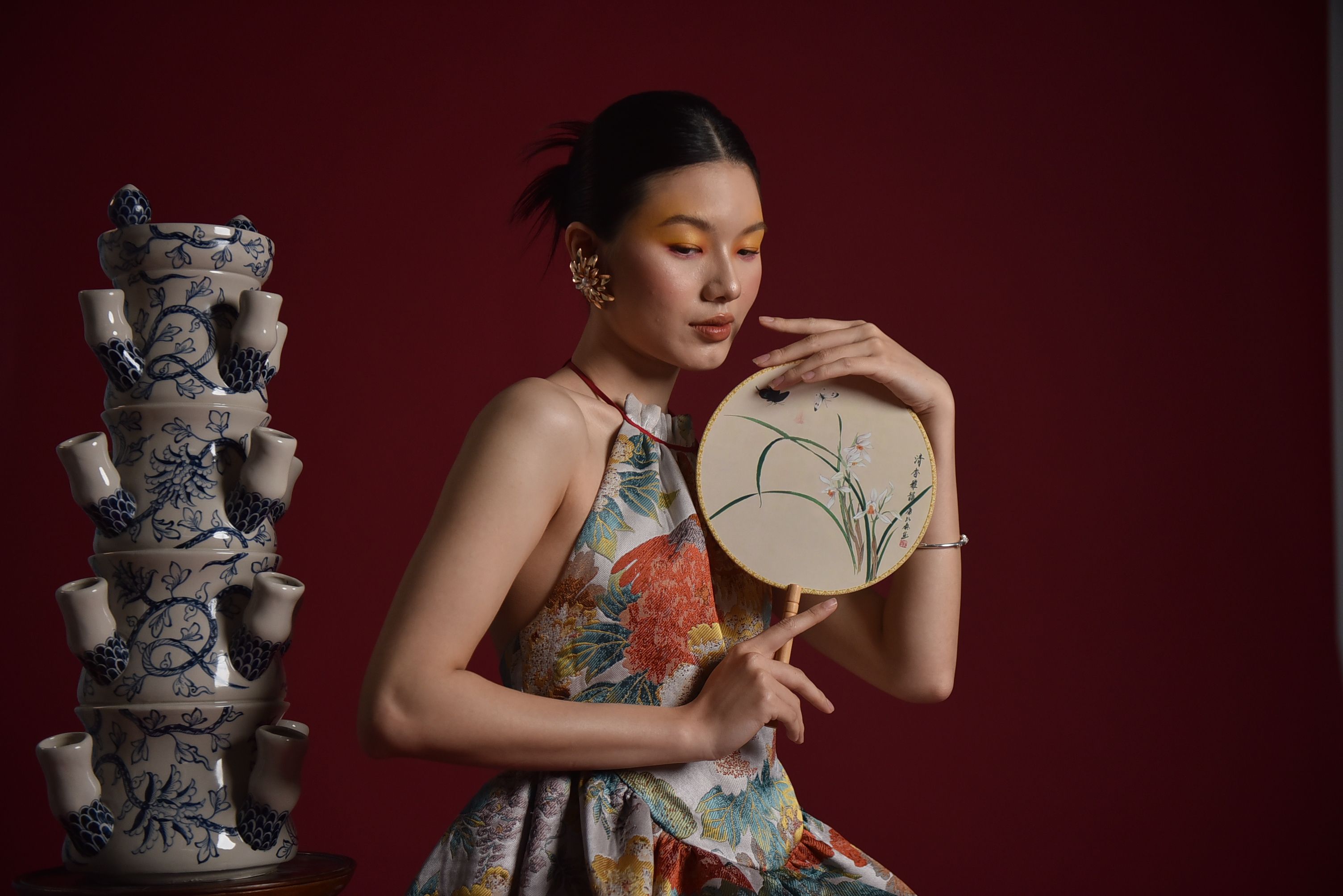 Elegant Woman with Decorative Ceramic and Fan · Free Stock Photo
