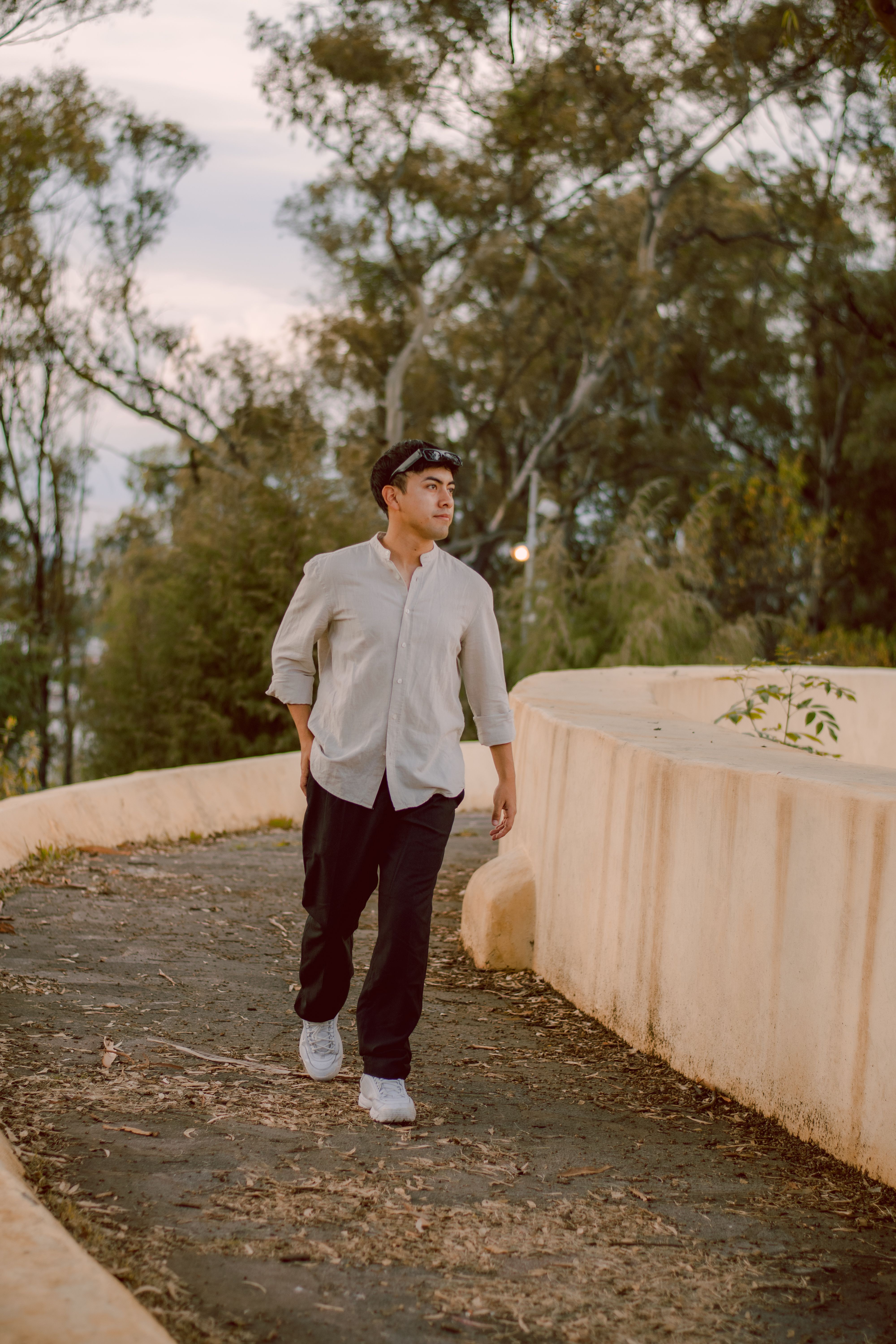 Man Walking in Scenic Park During Daytime Stroll · Free Stock Photo