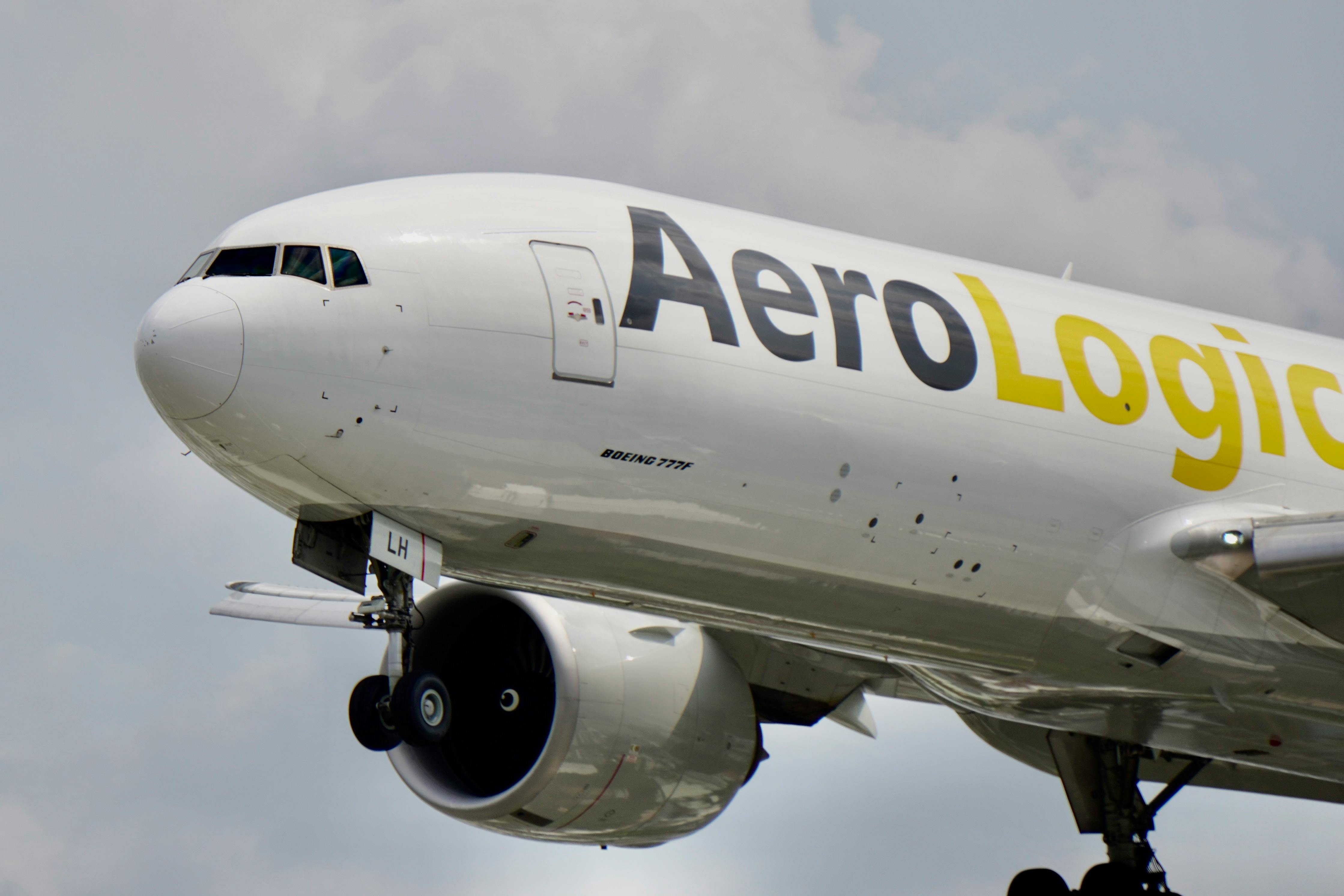 Free Close-up view of an AeroLogic Boeing 777F aircraft in-flight against a cloudy sky. Stock Photo