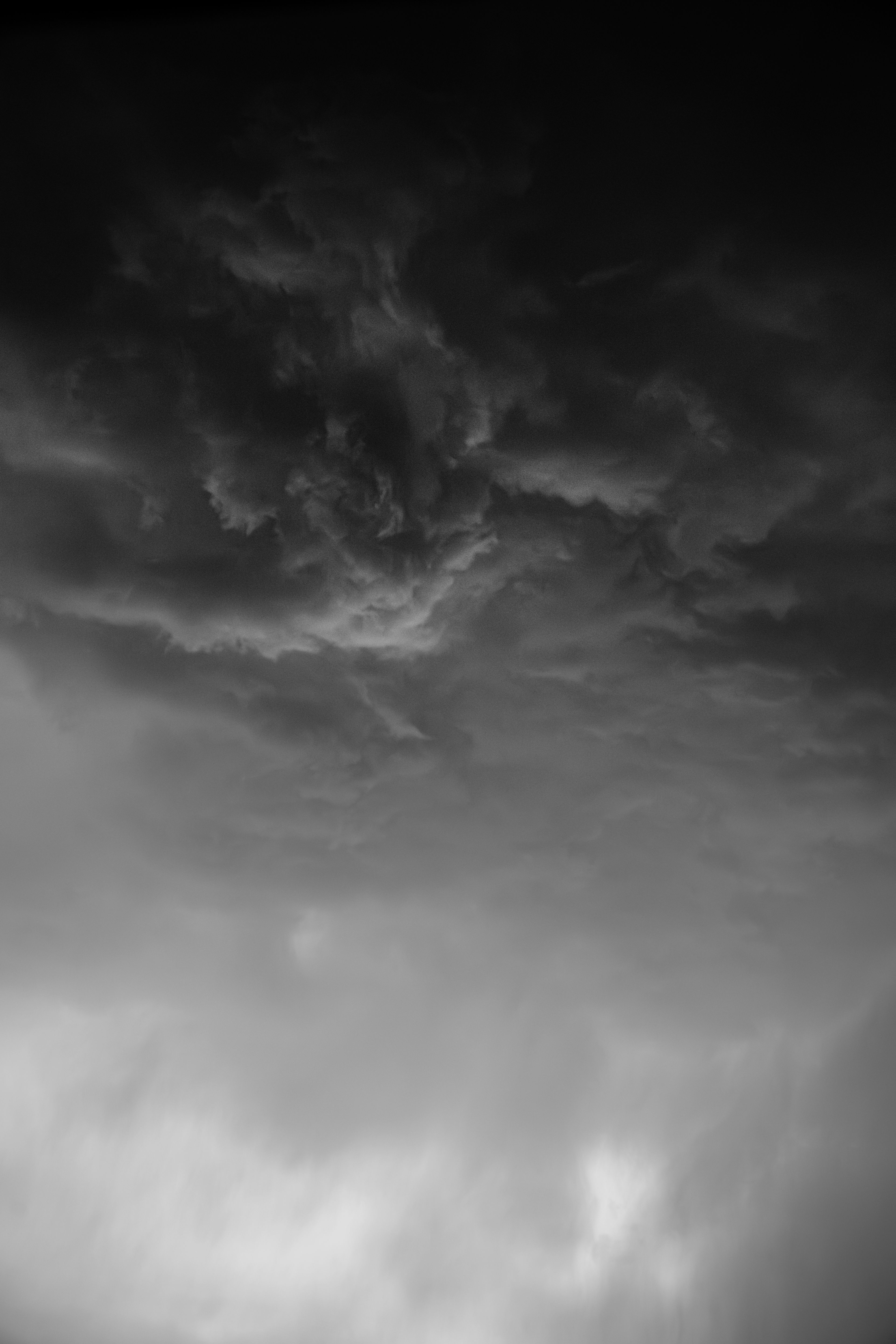 Moody black and white photograph capturing the intensity of storm clouds.