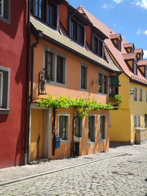 Free Charming European street with colorful buildings and classic architecture under a sunny sky. Stock Photo