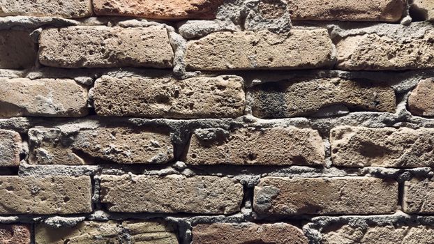 Detailed image of a rustic brick wall showcasing textures and patterns.