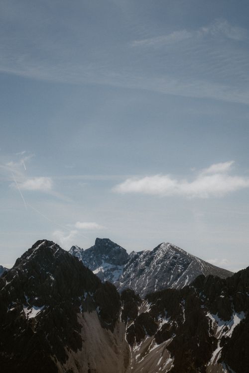 Free Stunning landscape of rugged mountain peaks and clear blue sky, ideal for nature themes. Stock Photo