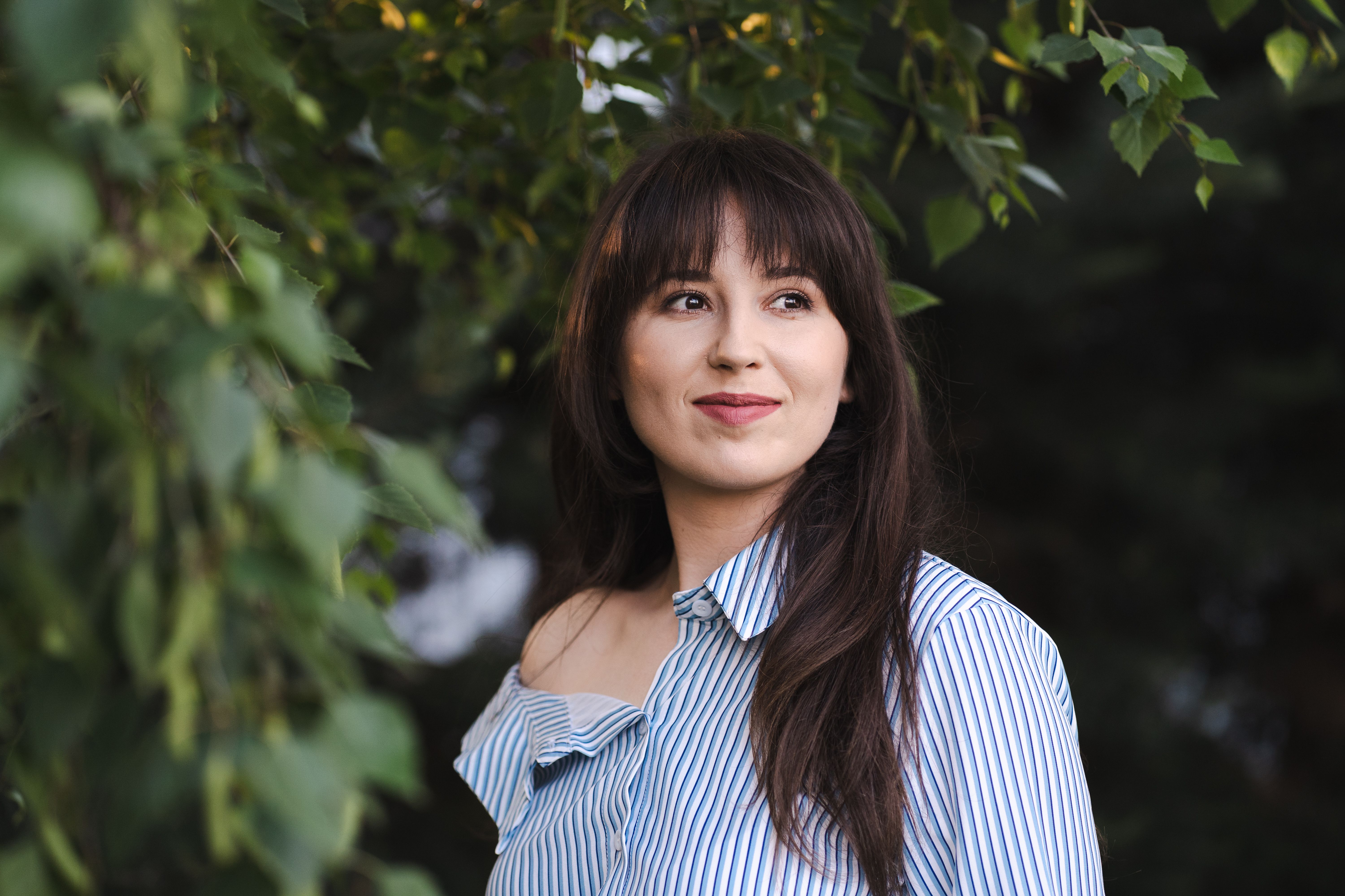 Smiling Woman in Striped Shirt Outdoors · Free Stock Photo