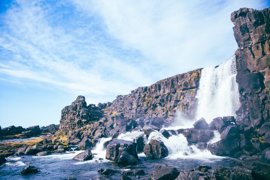 Discover the dramatic beauty of Öxarárfoss in Þingvellir, Iceland with this stunning waterfall scene.