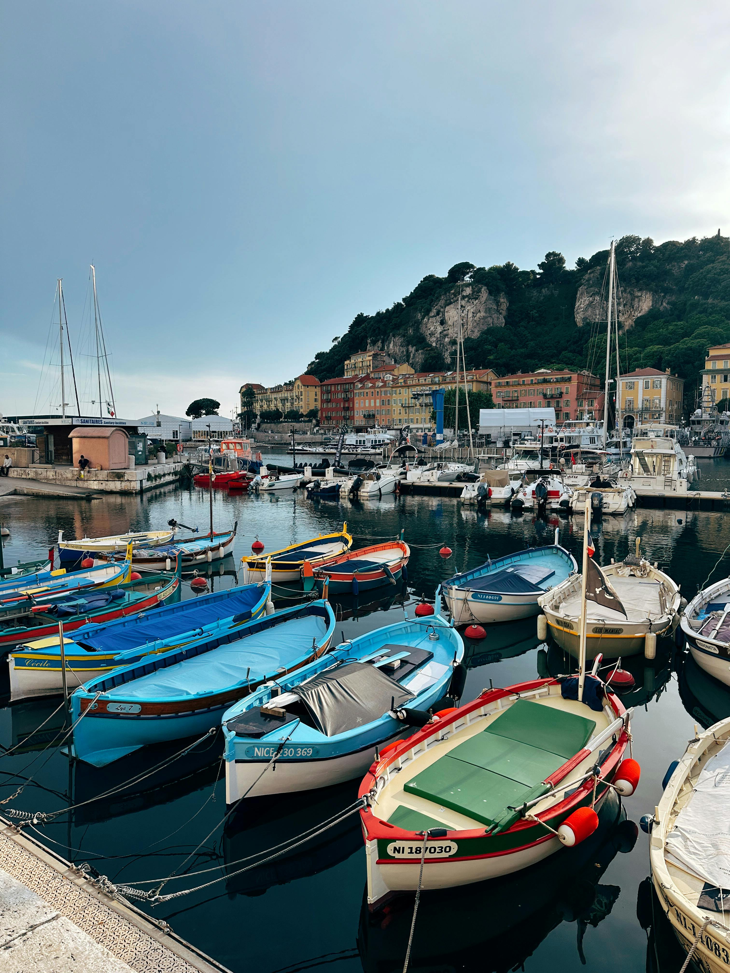Vibrant fishing boats docked in the picturesque harbor of Nice, France.
