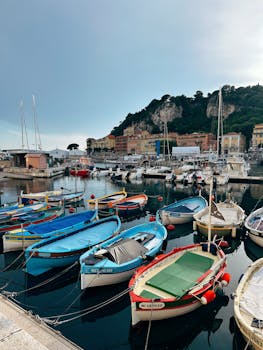 Vibrant fishing boats docked in the picturesque harbor of Nice, France.