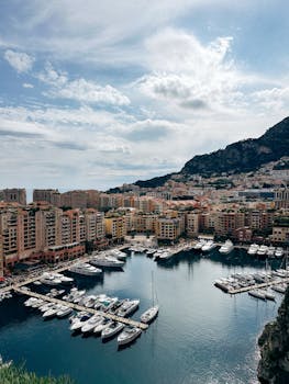 A spectacular view of Monaco's marina with yachts and Mediterranean architecture.
