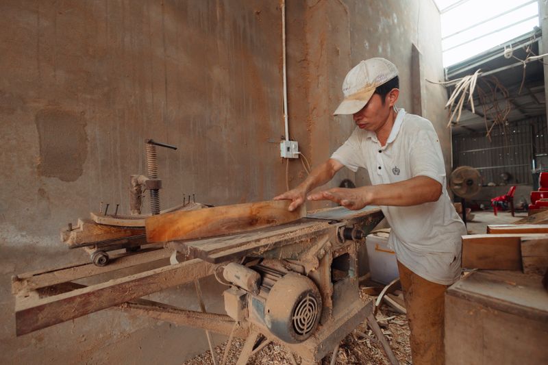 Carpenter cutting wood for custom modular furniture Carpenter cutting wood for custom modular furniture