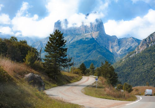 A scenic winding road leading to mountain views in Clelles, Auvergne-Rhône-Alpes, France.