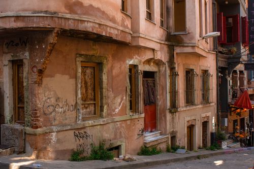 Free A rustic street scene showcasing aged architecture and vibrant urban life. Stock Photo