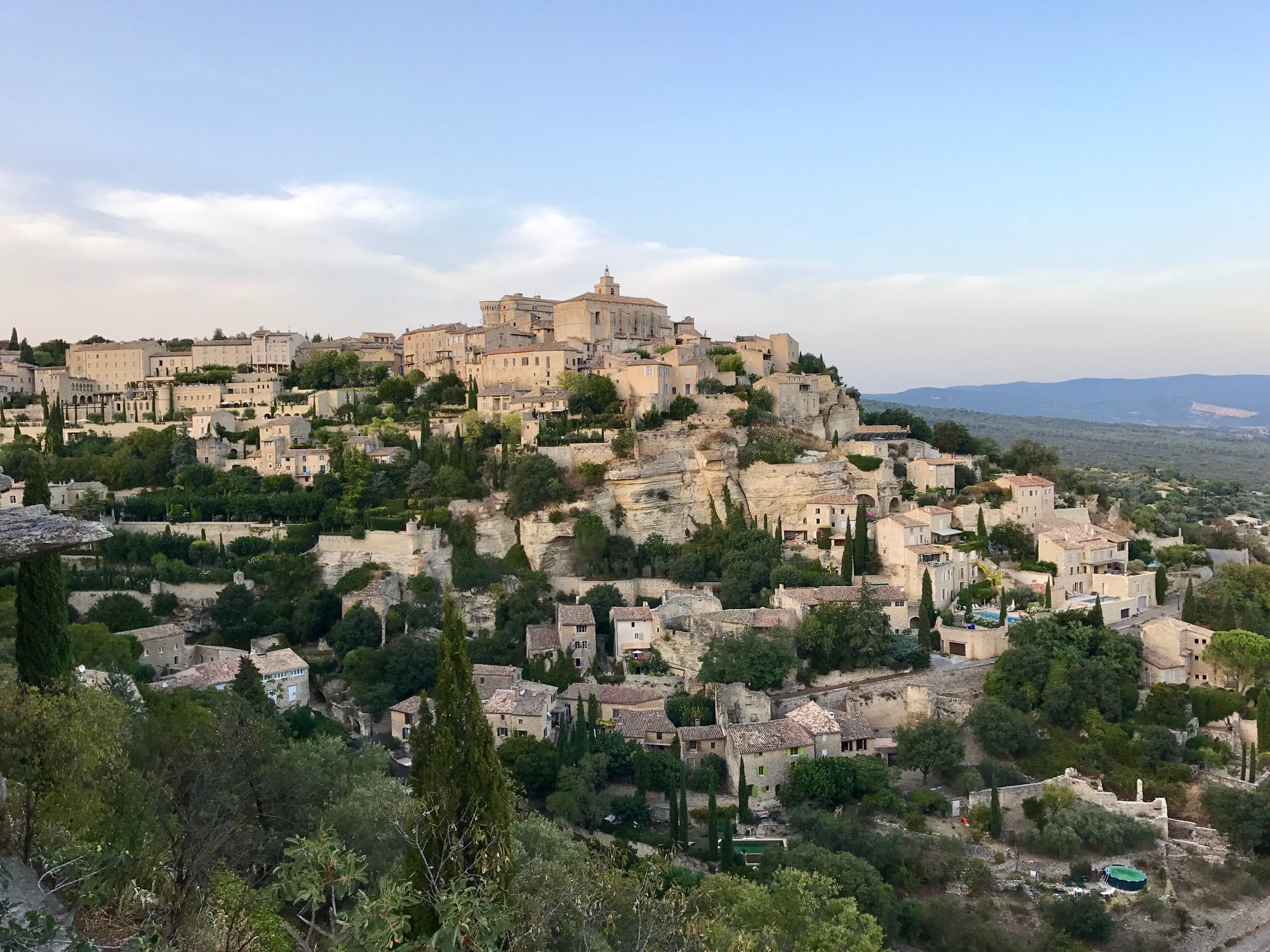 Panoramic view of the picturesque hilltop village of Gordes in Provence, France, at day. Panoramic view of the picturesque hilltop village of Gordes in Provence, France, at day.