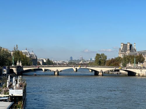 Free Stunning view of a classic Parisian bridge spanning the Seine River under a clear blue sky. Stock Photo