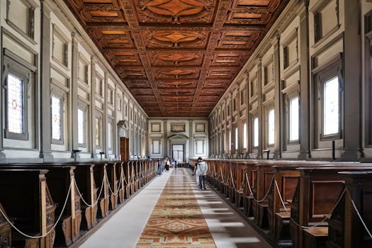 Explore the grand design of Biblioteca Medicea Laurenziana in Florence with its ornate wooden ceiling.